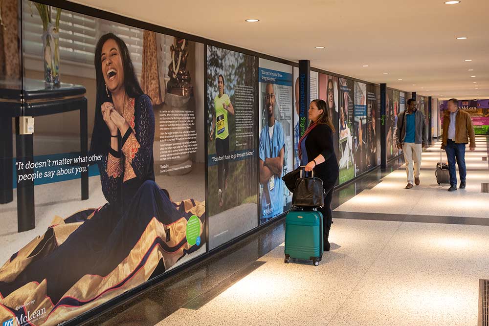 Travelers look at airport exhibit