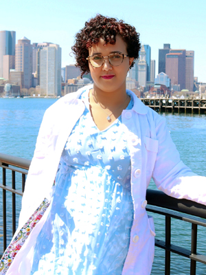 Woman in lab coat outside