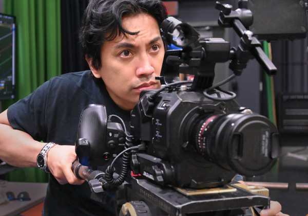 man behind a film camera