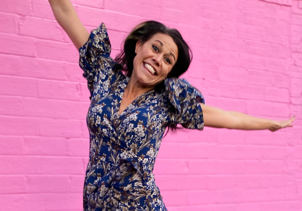 woman jumping with pink background
