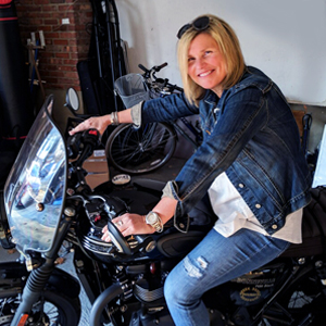 Blonde woman sitting on motorcycle
